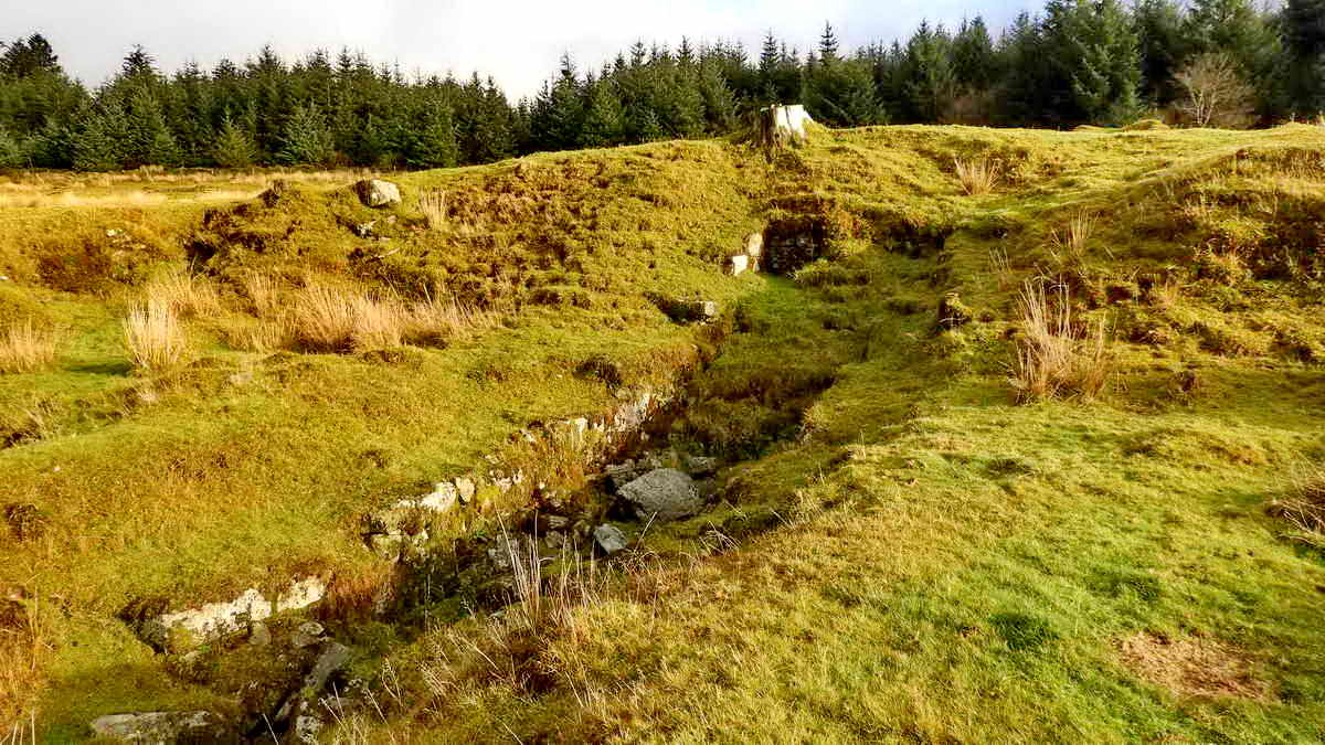 Large wheelpit, SX 57381 70118. This wheel was operating in 1830. Length of wheelpit 9 metres (30 feet) with a double-sided dressing floor and rectangular buddles. Source: Newman, Landscape, p.53